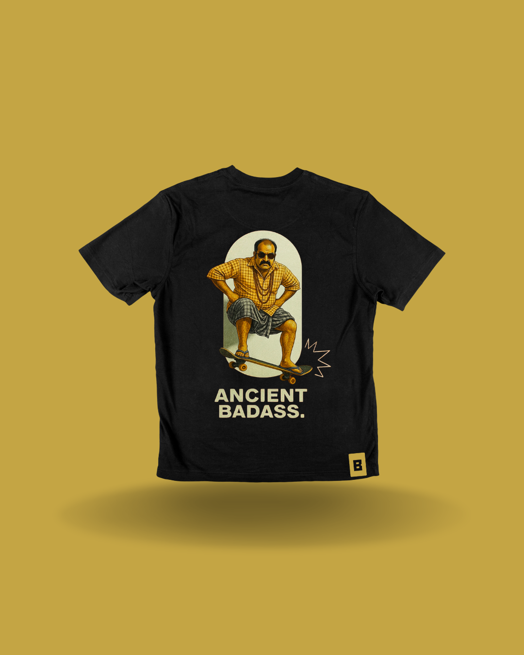 Black t-shirt with a retro illustration of a mundu-wearing uncle on a skateboard and the words 'Ancient Badass'