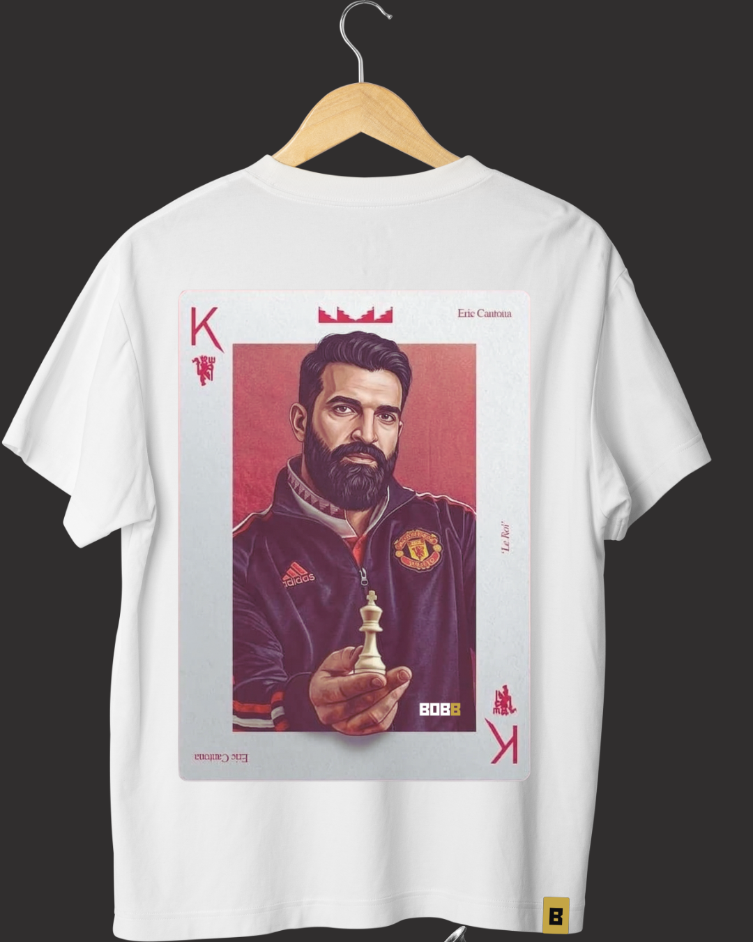 White oversized t-shirt on a hanger with a king playing-card artwork printed on the back