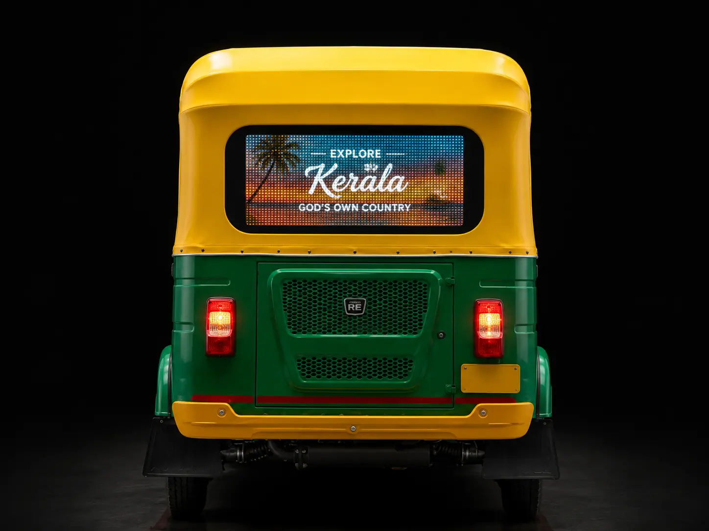 Rear of a yellow and green autorickshaw with an illuminated digital advertising screen showing a Kerala tourism creative.